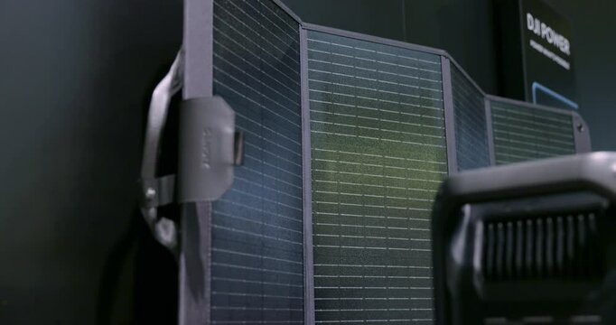 Close-up of a portable solar panel display at IFA, Berlin, highlighting its compact, eco-friendly design and textured surface