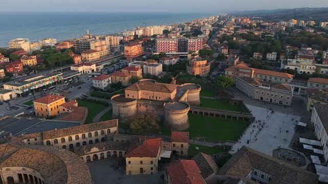 Aerial orbit of fortress in Senigallia, Italy over town with view of the sea