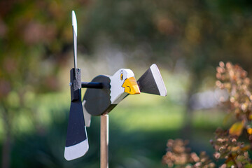 Wooden Seagull Wind Spinner in Garden with Soft Background Bokeh