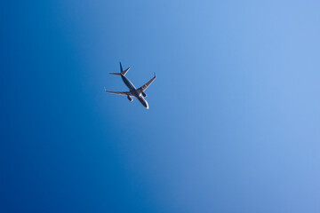 flying plane against the blue sky