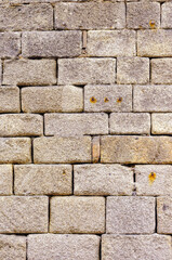 Obraz premium wall of granite ashlars in a Roman-period construction, textured background for archeology or architecture concept