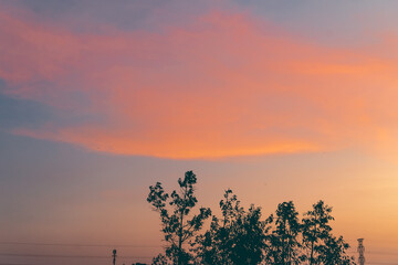Beautiful Sunset with Pink and Blue Sky over Church and City Landscape &ndash; Peaceful and Cozy Atmosphere
