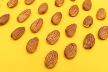 Almond nuts on yellow background