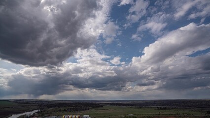 Endless Horizons: Cumulus Clouds Drifting Over Expansive Plains