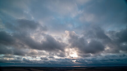 Autumn Drift: Gentle Cumulus Clouds in the Warm Glow of Pre-Sunset