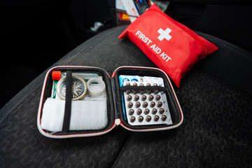 A wellequipped first aid kit can be conveniently found sitting on a car seat, ready for any...