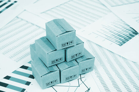 Shipment and cargo business concept. Shipping carton boxes on financial report.
