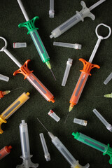 Multicolored syringes on a black background