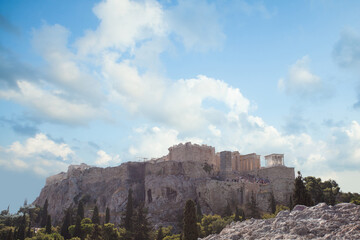 Pastel blue sky with white fluffy cloud and Acropolis hill. Athens, Greece