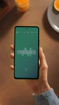 Vertical Screen POV Shot: Hand Holds a Smartphone, Person Using AI Chatbot Interface. Screen Shows Productivity Tips and Task Management Advice, AI Assistants Enhance Personal Efficiency.