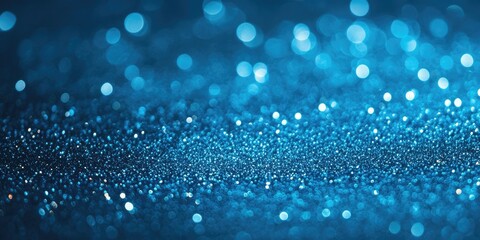Blurred blue glitter texture with sparkling effects, an abstract background for Christmas.