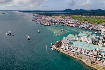 Aerial drone view of commercial pier and fisherman village at Semporna, a city on east coast of Sabah in Malaysia, Tawau District, Borneo island