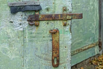 two old iron rusty simple retro industrial security bolted brown latches on green metal open green...