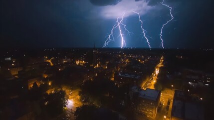 A nighttime aerial shot of a lightning storm over a city, with multiple lightning bolts illuminating the skyline