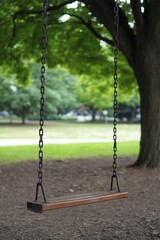 Park swing swaying peacefully in quiet nostalgia under gentle breeze. AI generated