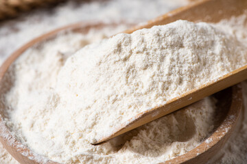 close up of white flour on wooden table
