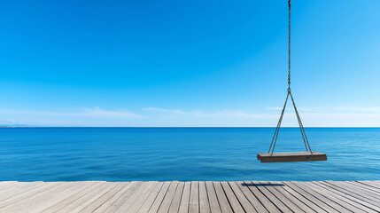 Obraz premium Tranquil wooden swing hanging over a serene blue sea from a pier, creating an idyllic vacation scene beneath a clear sky