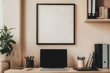 A black square frame hang on a light wall in a contemporary office setting. The workspace features a laptop, stationery holders, and shelves with books, creating a serene atmosphere.