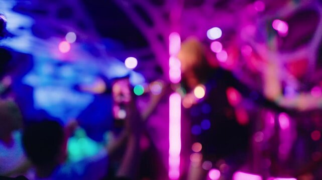 Experience the electrifying and dynamic vibes of a vibrant nightclub captured in stunningly defocused party footage