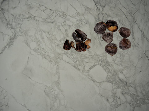 Roasted chestnuts on a stone kitchen top. Roasted chessnuts are part of the Portuguese autumn and winter traditions.