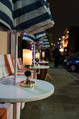 Tables of an outdoor restaurant. The candle is on the table. Minsk nightlife