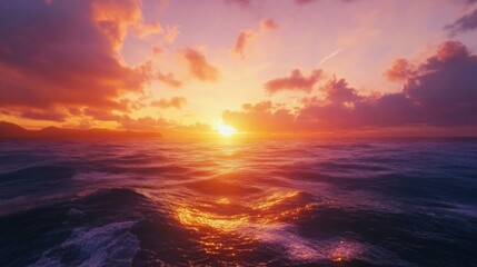 Obraz premium A vibrant sunset over the ocean, sky painted with shades of orange, pink, and purple