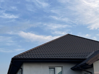 The roof is made of black metal tiles. A steel ridge was laid