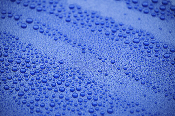 Closeup blue car paint surface with hydrophobic ceramic coating