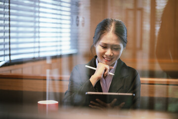 Asian businesswoman relaxing in a modern office