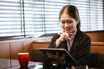 Asian businesswoman relaxing in a modern office