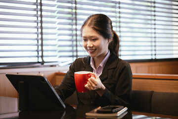 Asian businesswoman relaxing in a modern office