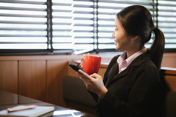 Asian businesswoman relaxing in a modern office