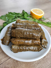  Traditional oriental Turkish dolma made of grape leaves stuffed with rice on a decorative plate