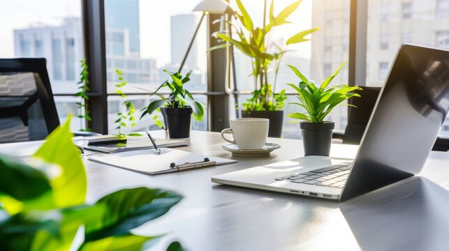 A bright and modern office workspace featuring a laptop, plants, and a coffee cup, perfect for productive moments in a serene environment