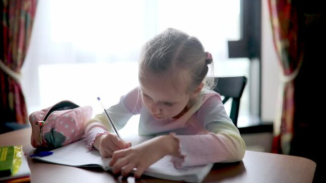 Schoolgirl doing her homework at home