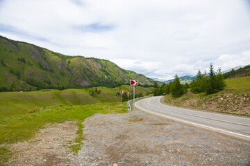 Awe summer mountains landscape with winding asphalt road in the Altai Republic, Russia. Federal...
