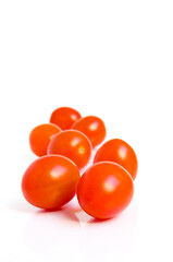 tomatoes isolated on white background with selective focus on the first few tomatoes.