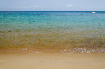 Tropical beach scene  with turquoise coloured water somewhere in on a bounty island. Summer holiday in a country with a warm climate