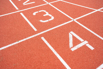 Fototapeta premium Numbers of the finish line at an athletics track outside. Numbers two, three and four visible. Horizontal shot, no people.