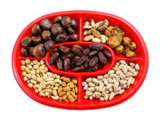 Red divided platter presenting assortment of nuts and dried fruits