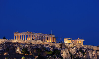 Parthenon illuminating the athenian acropolis at twilight, greece