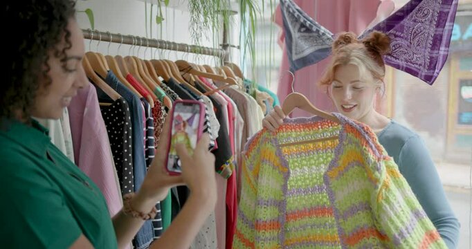 Female Friends Taking Pictures with Phone in Vintage Clothes Shop