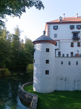 Scenic, historic Sneznik castle. Beautiful Slovenian national monument. Imposing ancient fortification surrounded by a tranquil moat. Charming well preserved old building.