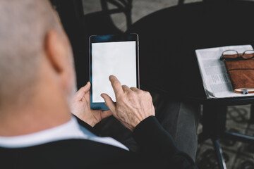 Respectable entrepreneur reading news during break
