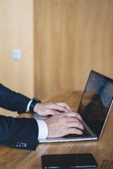 Crop manager browsing laptop at desk