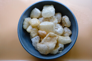 Top View of Kerupuk Kulit (Fried Crackling Snack) in Bowl: Authentic Indonesian Snack - Ideal for Food-Themed and Cultural Photography
