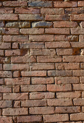 Background with old wall made with handmade brick made out of clay.