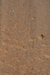old brick wall plastered with clay sand and lime, washed by the rain