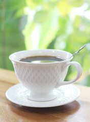 Hot black coffee in a glass on the table