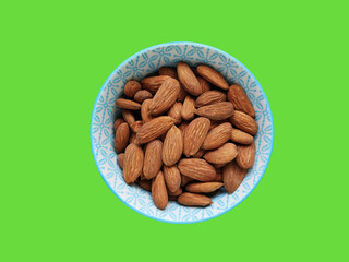 Natural roasted brown almonds in a decorative plate 